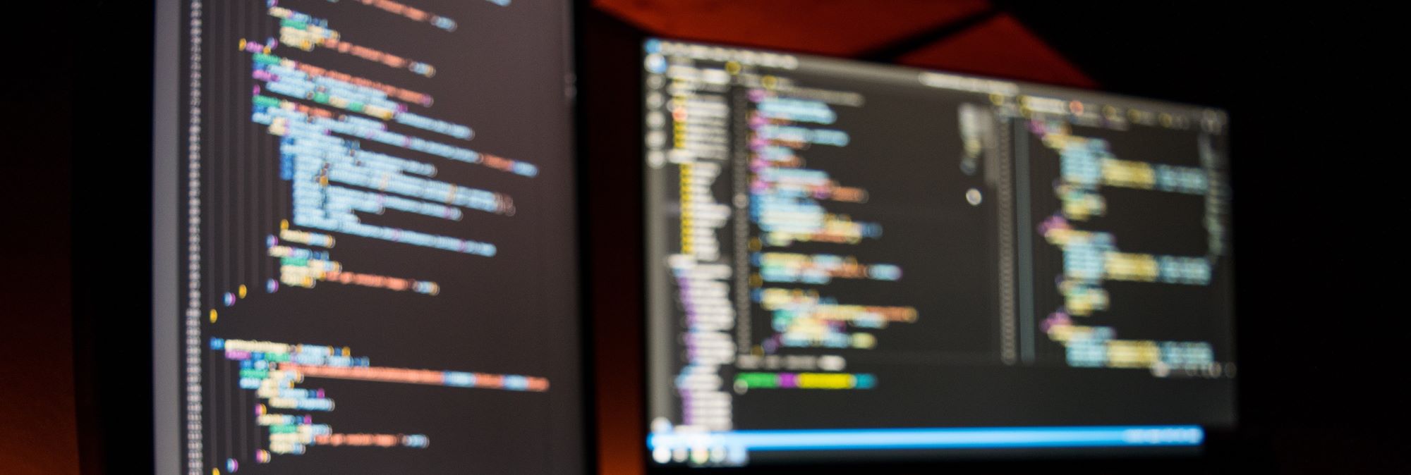 Photograph of blurred out code on a computer screens